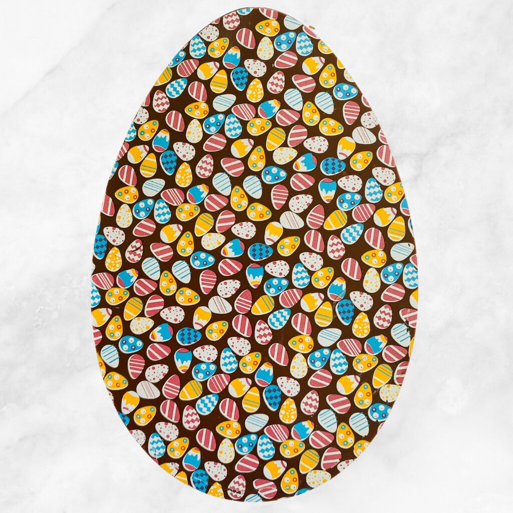 
                  
                    Front of a flat Easter Egg from Sweet C's Chocolates with colourful Easter design
                  
                