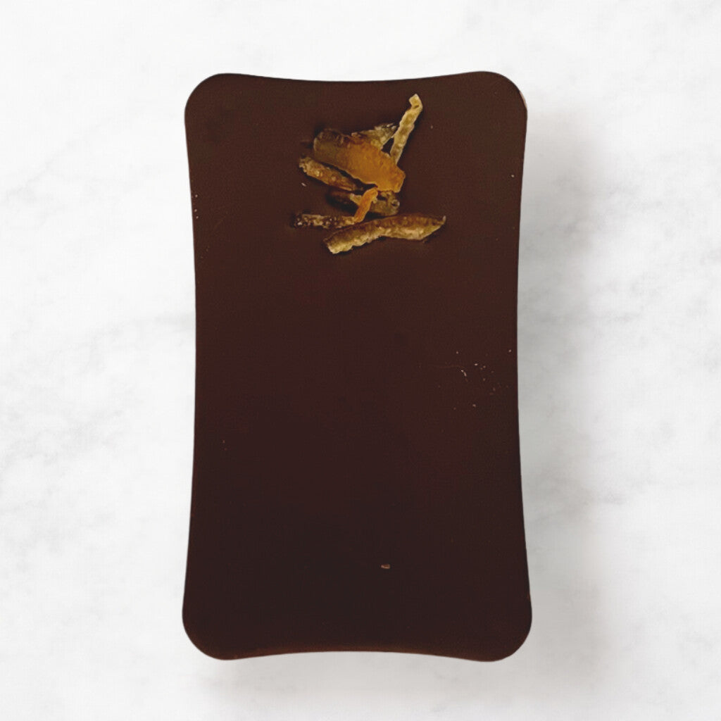 
                  
                    Milk chocolate bar with dried orange pieces on a white background
                  
                