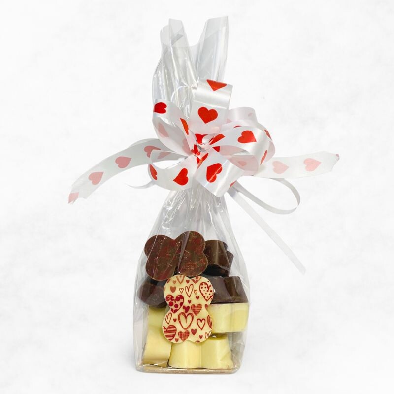 
                  
                    Assorted heart chocolates in a clear  bag with a decorative ribbon on a white background
                  
                